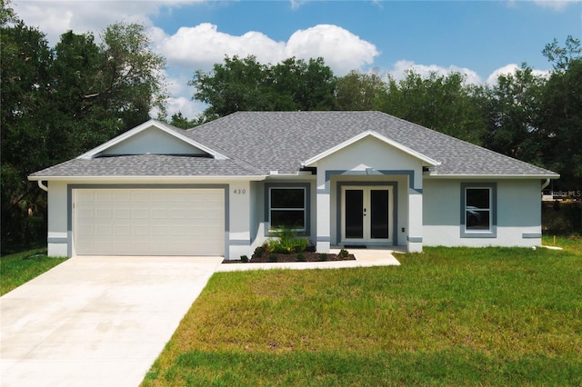 ranch-style house featuring a garage and a front lawn