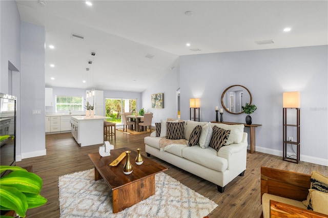 living room with dark hardwood / wood-style floors and high vaulted ceiling