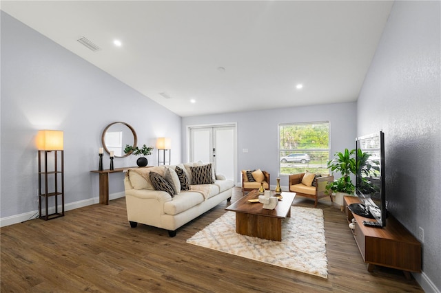 living room featuring french doors, dark hardwood / wood-style flooring, and vaulted ceiling