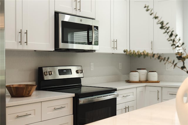 kitchen featuring white cabinetry and appliances with stainless steel finishes