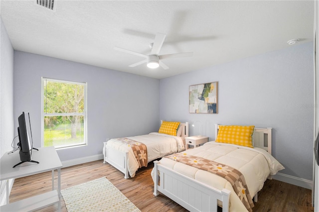 bedroom with light wood-type flooring and ceiling fan