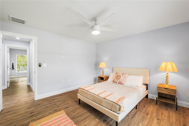 bedroom with wood-type flooring and ceiling fan