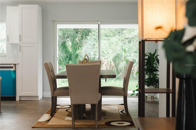 dining area with a wealth of natural light and hardwood / wood-style floors