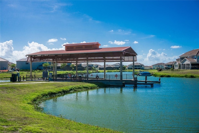 view of dock featuring a water view and a lawn