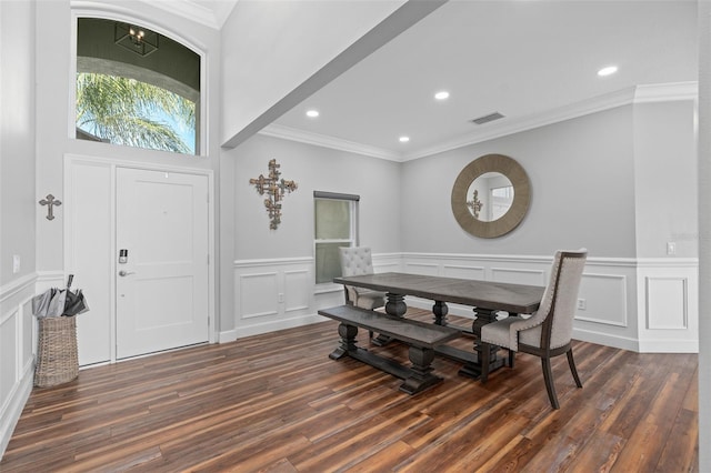 dining space with crown molding and dark hardwood / wood-style floors