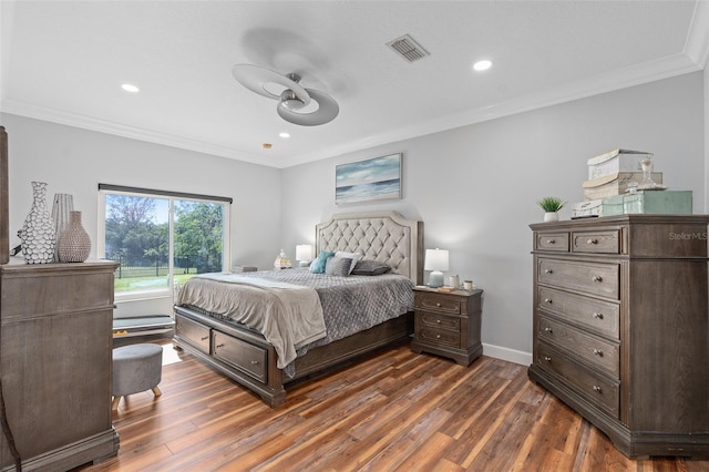 bedroom with ornamental molding, dark wood-type flooring, and ceiling fan