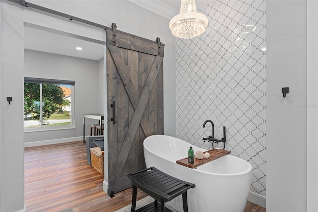 bathroom with a bathtub, wood-type flooring, and ornamental molding