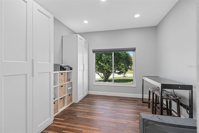 home office with dark hardwood / wood-style floors