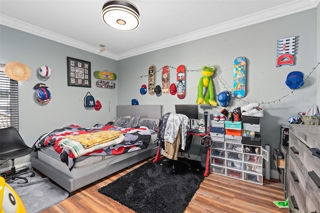 bedroom featuring hardwood / wood-style flooring and ornamental molding