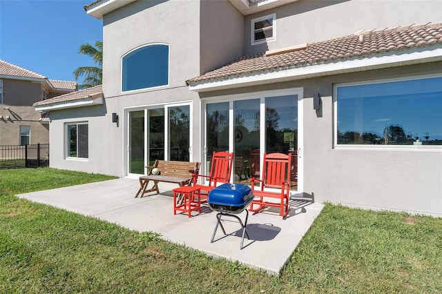 rear view of property featuring a patio and a lawn