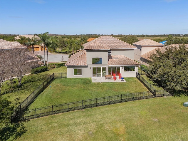 back of house with a lawn and a patio area