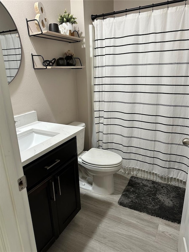 bathroom featuring hardwood / wood-style floors, toilet, and vanity