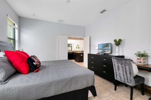 tiled bedroom featuring ensuite bathroom