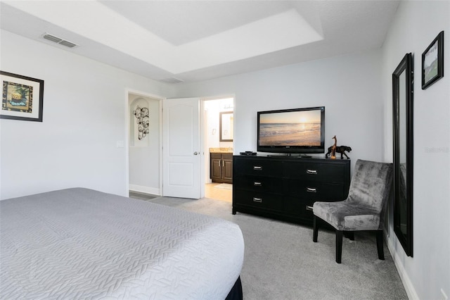 carpeted bedroom with connected bathroom