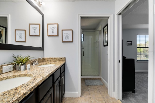 bathroom featuring tile patterned floors, vanity, and a shower with shower door