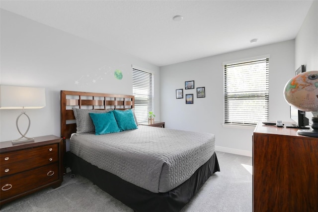 bedroom featuring light carpet