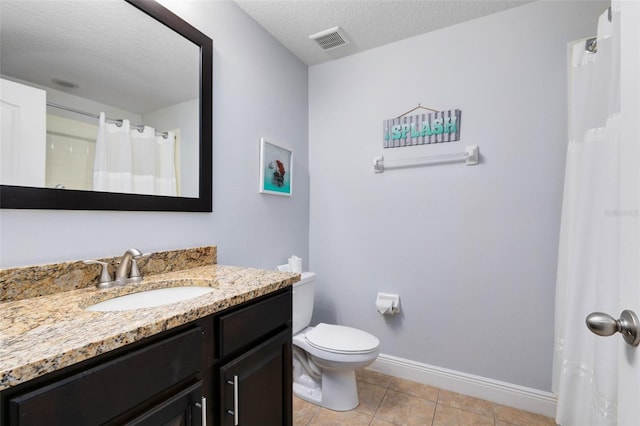 bathroom featuring vanity, a textured ceiling, tile patterned floors, and toilet