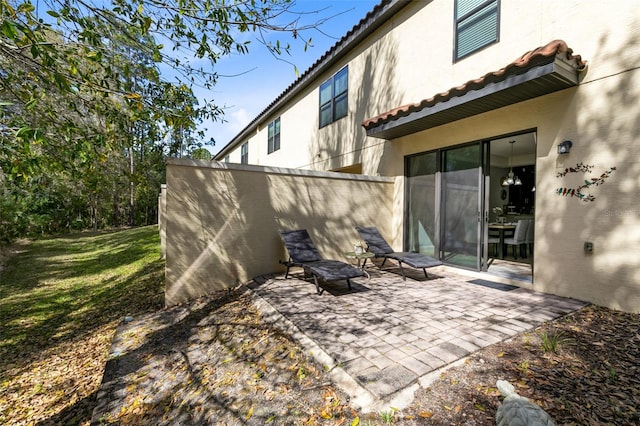 back of house with a patio area and a yard