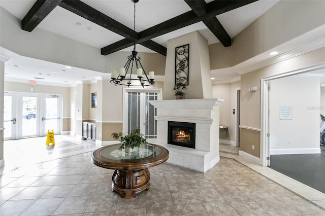 interior space featuring a high end fireplace, coffered ceiling, light tile patterned floors, beam ceiling, and a chandelier