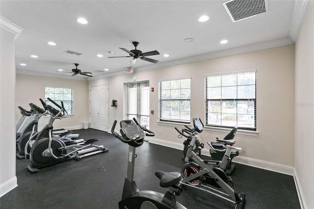 workout area with crown molding, ceiling fan, and a textured ceiling