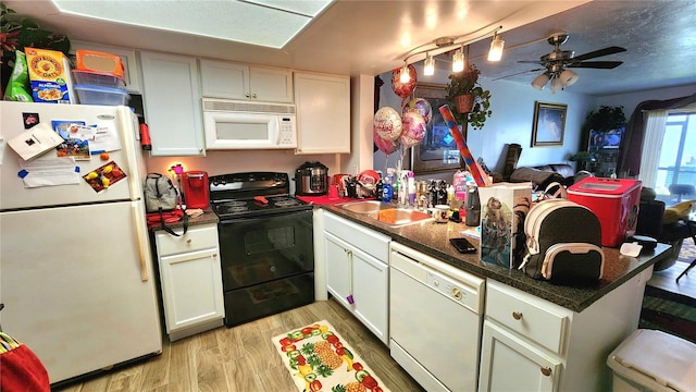 kitchen with ceiling fan, kitchen peninsula, light hardwood / wood-style flooring, white appliances, and white cabinets