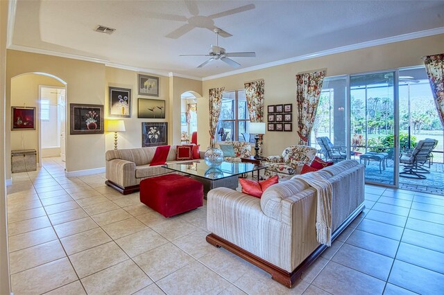 tiled living room with crown molding and ceiling fan