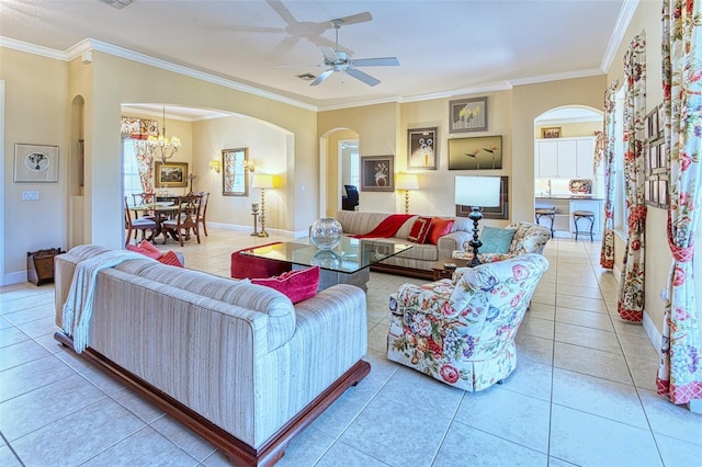 living room with crown molding, ceiling fan with notable chandelier, and light tile floors