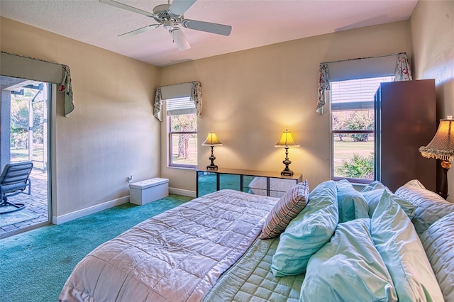 carpeted bedroom featuring ceiling fan, access to exterior, and a textured ceiling