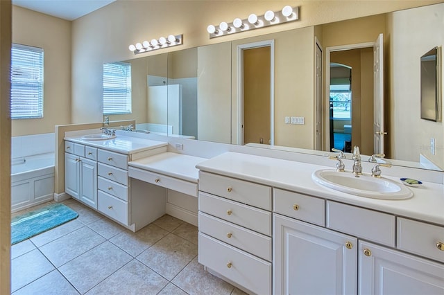 bathroom with large vanity, tile floors, and a washtub