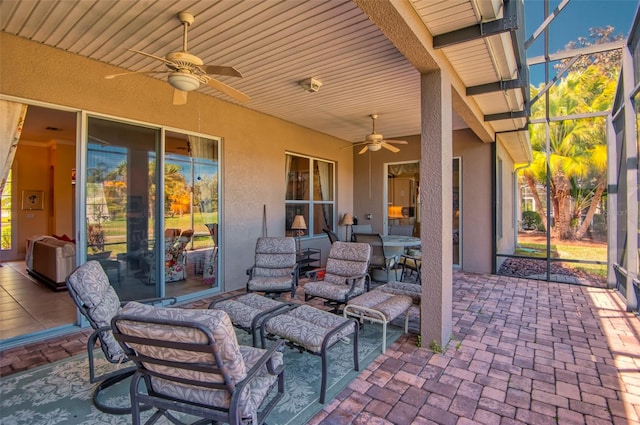 view of patio / terrace with ceiling fan and glass enclosure