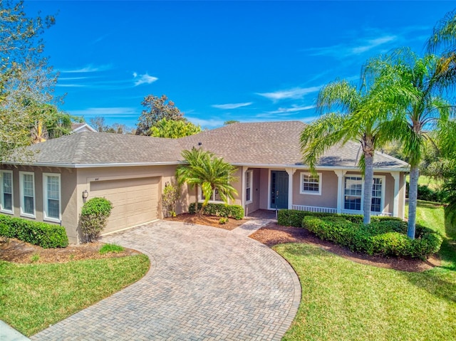 ranch-style home featuring a front yard and a garage