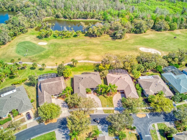 aerial view with a residential view, view of golf course, and a water view