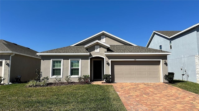 view of front of home featuring a front lawn and a garage