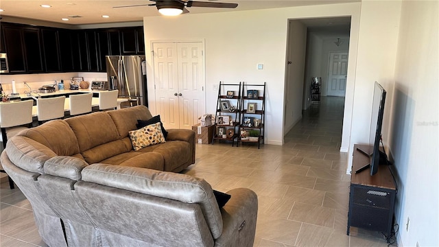 tiled living room featuring ceiling fan