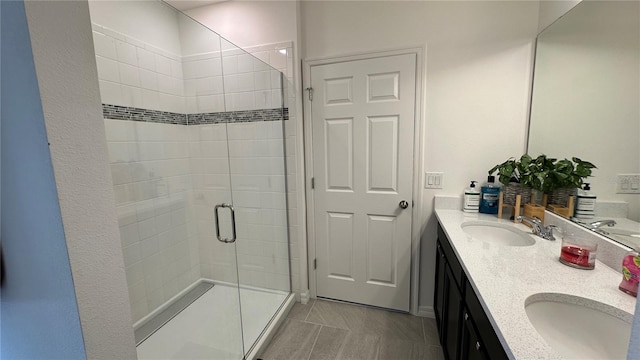 bathroom with double sink, oversized vanity, and walk in shower