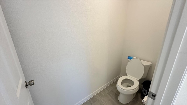 bathroom featuring toilet and tile floors