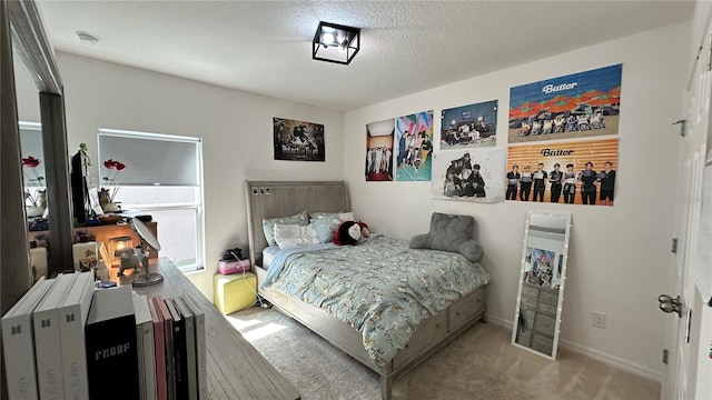 bedroom featuring light carpet and a textured ceiling