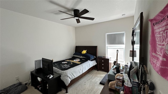 carpeted bedroom with a textured ceiling and ceiling fan