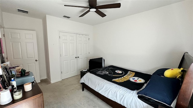 carpeted bedroom with a closet and ceiling fan