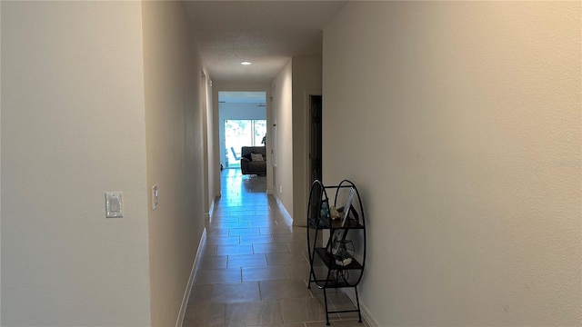 hall with light tile flooring