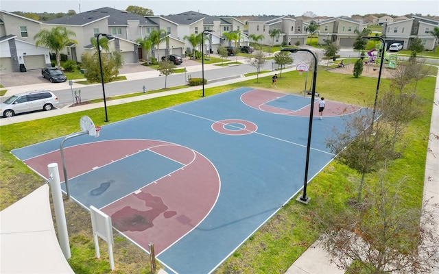 view of basketball court with a lawn