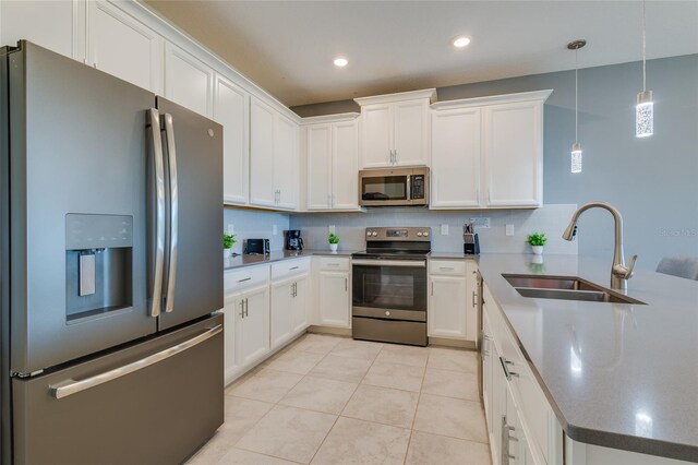 kitchen featuring light tile floors, white cabinets, sink, and stainless steel appliances