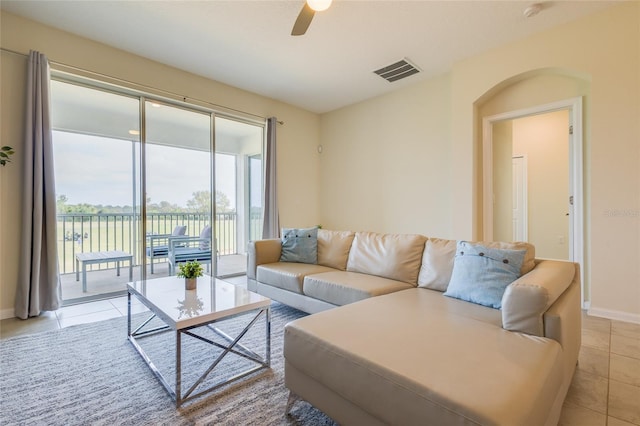 tiled living room with ceiling fan