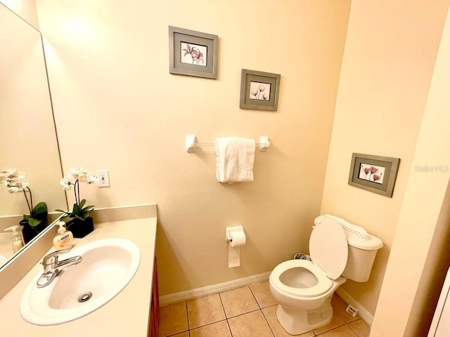 bathroom featuring tile patterned floors, vanity, and toilet