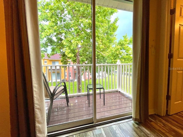 doorway to outside with wood-type flooring