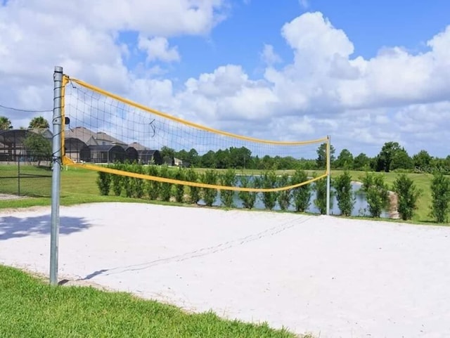 view of property's community featuring volleyball court and a water view