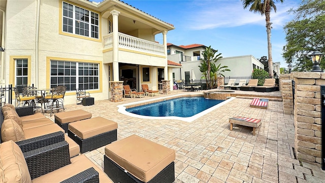 view of swimming pool with an in ground hot tub, outdoor lounge area, and a patio