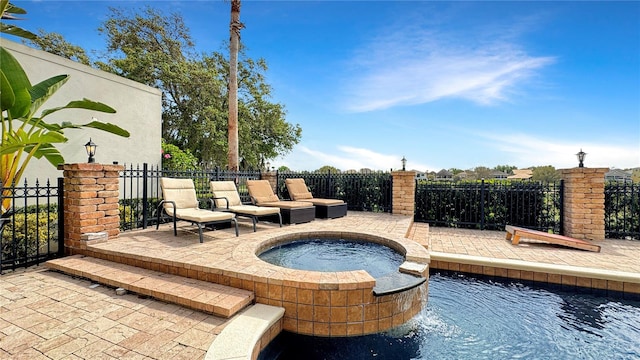 view of swimming pool with an in ground hot tub and a patio area