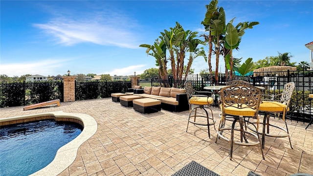 view of swimming pool featuring an outdoor living space and a patio