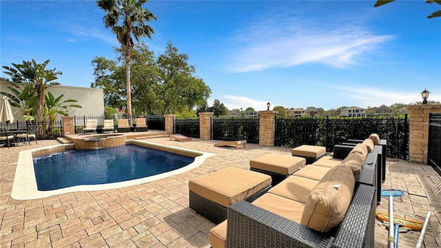 view of pool featuring a patio area and an in ground hot tub